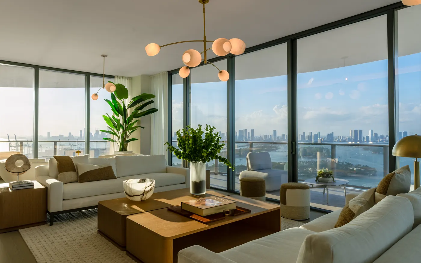 A Five Park living room with floor-to-ceiling windows over the bay