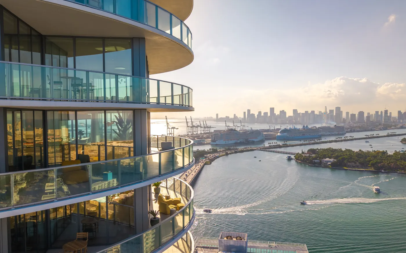 The curved terraces of Five Park above Biscayne Bay and the Miami skyline
